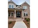 A close-up of a home's front entrance and walkway, showing a brick facade, porch and sidelights at 4125 Sierra Vista Cir, Cumming, GA 30040