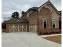 This home features a large garage with two doors and a long driveway at 4125 Sierra Vista Cir, Cumming, GA 30040