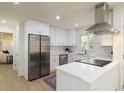 Stainless steel appliances and white cabinets complement the modern kitchen's bright design at 605 Patrick Ne Pl, Sandy Springs, GA 30328