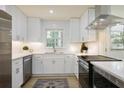 Bright kitchen with white cabinets, stainless steel appliances, and modern finishes at 605 Patrick Ne Pl, Sandy Springs, GA 30328