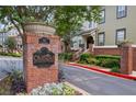 Brick signage for Oldfield at Grant Park, lush landscaping, and attractive townhome exteriors at 655 Mead Se St # 58, Atlanta, GA 30312