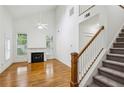 Open-concept living room with fireplace, staircase, and hardwood floors at 655 Mead Se St # 58, Atlanta, GA 30312