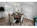 Bright dining area features wood floors, modern chandelier, and a table set for eight, ideal for entertaining at 902 Ashton Oak Cir, Stone Mountain, GA 30083