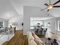 Open living space with hardwood floors, bar seating, open access to kitchen, and a view of the dining room at 902 Ashton Oak Cir, Stone Mountain, GA 30083