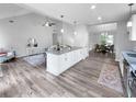 Open living space with island, eat-in kitchen, stainless appliances, sleek countertops and hardwood floors at 902 Ashton Oak Cir, Stone Mountain, GA 30083