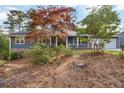 View of the home with blue siding and stone foundation, complemented by a well-maintained front yard at 2142 Graystone Pkwy, Grayson, GA 30017