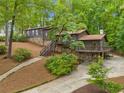 Beautiful exterior showcasing stone accents, wood siding, a deck, and a well-maintained yard at 475 Nottingham Dr, Marietta, GA 30066