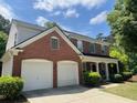 Charming two-story brick home with a well-maintained lawn and an attached two-car garage at 663 Prada Ct, Lawrenceville, GA 30043