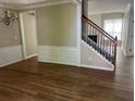 Open-concept living area with hardwood floors and a staircase with a wrought iron railing at 663 Prada Ct, Lawrenceville, GA 30043