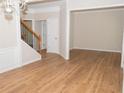 Bright living room features new flooring, crown molding, and is located near staircase at 663 Prada Ct, Lawrenceville, GA 30043