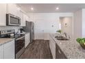 Stylish kitchen with granite countertops, stainless steel appliances, and modern fixtures at 2010 Vidalia Ct, Dacula, GA 30019
