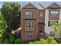 Inviting brick townhome featuring a classic design and manicured front garden at 2020 Jardin Ct # 1, Alpharetta, GA 30022
