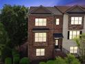Traditional brick townhome with a well-manicured lawn and covered entryway at 2020 Jardin Ct # 1, Alpharetta, GA 30022