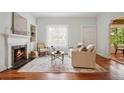Cozy living room with fireplace, hardwood floors, and neutral furnishings at 615 Sycamore Dr, Decatur, GA 30030