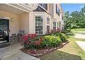 Beautiful townhome exterior featuring lush greenery and vibrant red roses in the front yard at 7324 Bridlewood Ct, Jonesboro, GA 30236