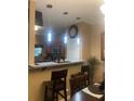 Eat-in kitchen with pendant lights, bar-top counter, and stainless steel appliances at 7324 Bridlewood Ct, Jonesboro, GA 30236