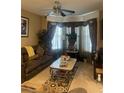 Cozy living room features a large sectional sofa and decorative curtains at 7324 Bridlewood Ct, Jonesboro, GA 30236
