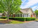 Beautiful front exterior of a single-story home with lush landscaping and a mature shade tree at 106 Vintage Club Cir, Marietta, GA 30066