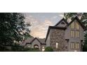 Beautiful stone and stucco exterior with large windows under an overcast sky at 1440 Northwold Dr, Atlanta, GA 30350