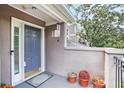 Inviting front entry with covered porch, attractive blue door, and decorative potted plants at 59 Saint Claire Ne Ln, Atlanta, GA 30324