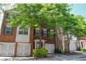 Brick townhome with well-maintained landscaping, charming shutters, and a convenient one-car garage at 2201 Landing Walk Dr, Duluth, GA 30097