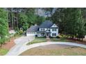 A bird's eye view of a beautiful home surrounded by mature trees, with a long driveway at 4985 Miller Sw Rd, Lilburn, GA 30047