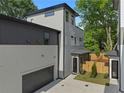 Side view of the modern home featuring an attached garage and neutral-colored siding at 88 Cleveland Unit B Se St, Atlanta, GA 30316