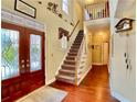 Inviting foyer with hardwood floors, a staircase, and a decorative glass front door at 1093 Spruce Creek Ln, Lawrenceville, GA 30045