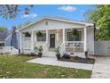 Inviting bungalow with a charming front porch, featuring modern railings and decorative plants at 176 Rhodesia Se Ave, Atlanta, GA 30315