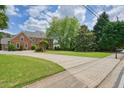 A large house features a brick exterior, a sprawling lawn, and a long driveway at 3689 Spring Hill Se Rd, Smyrna, GA 30080