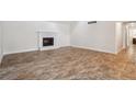 Bright living room featuring a fireplace and wood-look tile flooring at 3783 Ardsley Ct, Marietta, GA 30062
