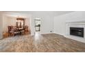 Open living and dining area featuring a fireplace and chandelier at 3783 Ardsley Ct, Marietta, GA 30062