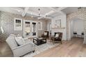 Cozy living room with brick walls, fireplace, wood floors, comfortable seating, and plenty of natural light at 7275 Cordery Rd, Cumming, GA 30040