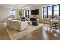 Spacious living room with large windows, modern furnishings, and stunning city views at 88 W Paces Ferry # 2230, Atlanta, GA 30305