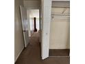 Carpeted hallway featuring a closet and an open doorway leading to other areas of the home at 102 Governors Dr, Forest Park, GA 30297