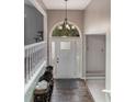 Inviting entryway with hardwood floors and a charming decorative light fixture at 204 Queensbury Ct, Acworth, GA 30102