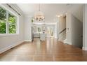 Open-concept living area with hardwood floors, kitchen view, and a staircase, blending living spaces at 2093 Callaway Nw Ct, Atlanta, GA 30318