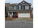 Charming two-story home with blue siding, black shutters, brick accents, and a two-car garage at 28 Samuel Nw Way, Cartersville, GA 30121