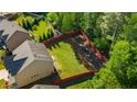 Expansive backyard featuring a well-maintained lawn, surrounded by a privacy fence and mature trees at 4830 Frontier Dr, Cumming, GA 30028