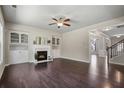 Inviting living room with hardwood floors, fireplace, built-in shelving, and ample natural light at 4830 Frontier Dr, Cumming, GA 30028