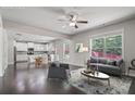 Open concept living room and kitchen with stainless steel appliances and hardwood floors at 4830 Frontier Dr, Cumming, GA 30028