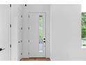Bright entryway with white walls, wood floors, and a modern front door at 90 Cleveland Unit A Se St, Atlanta, GA 30316