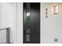 Modern black front door with vertical window and stylish exterior lighting at 90 Cleveland Unit A Se St, Atlanta, GA 30316