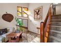 Bright foyer with hardwood stairs, unique windows, and decorative accents at 140 N Star Sw Trl, Atlanta, GA 30331