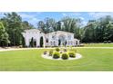 Spacious home with manicured lawn, fountain, and lush trees offers curb appeal and a serene outdoor space at 2425 Wild Oak Ct, Stockbridge, GA 30281
