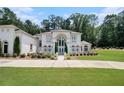 Luxury home with immaculate lawn, mature trees, and well-manicured bushes offers stunning curb appeal at 2425 Wild Oak Ct, Stockbridge, GA 30281