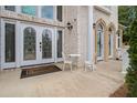 Inviting front entrance with decorative glass doors, seating, and a welcoming doormat at 2425 Wild Oak Ct, Stockbridge, GA 30281