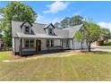 Attractive two-story house featuring a covered porch and a double garage, set on a well-maintained lawn at 2979 Overwood Sw Ln, Snellville, GA 30078