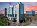 Contemporary high-rise building with glass facade, multiple balconies, and well maintained landscaping at 3300 Windy Ridge Se Pkwy # 1401, Atlanta, GA 30339