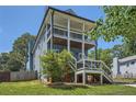Two-story home boasts dual porches, blue siding, and a lush front lawn at 632 Warren Ave, Scottdale, GA 30079